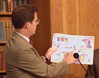 Senator Sam Brownback (R-KS) shows a picture of a machine gun drawn by a Sudanese child. Senator Brownback and Representative Frank Wolf (R-VA) held a press conference in Washington, DC, on July 6, 2004, to report on their recent trip to western Sudan. The lawmakers offered policy recommendations for how the United States and the United Nations could help discourage the ethnic cleansings that have up killed or uprooted tens of thousands of Sudanese.